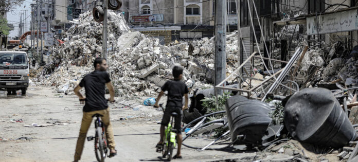 A-tower-block-lies-in-ruins-in-Gaza-city-after-an-Israeli-air-strike..jpg